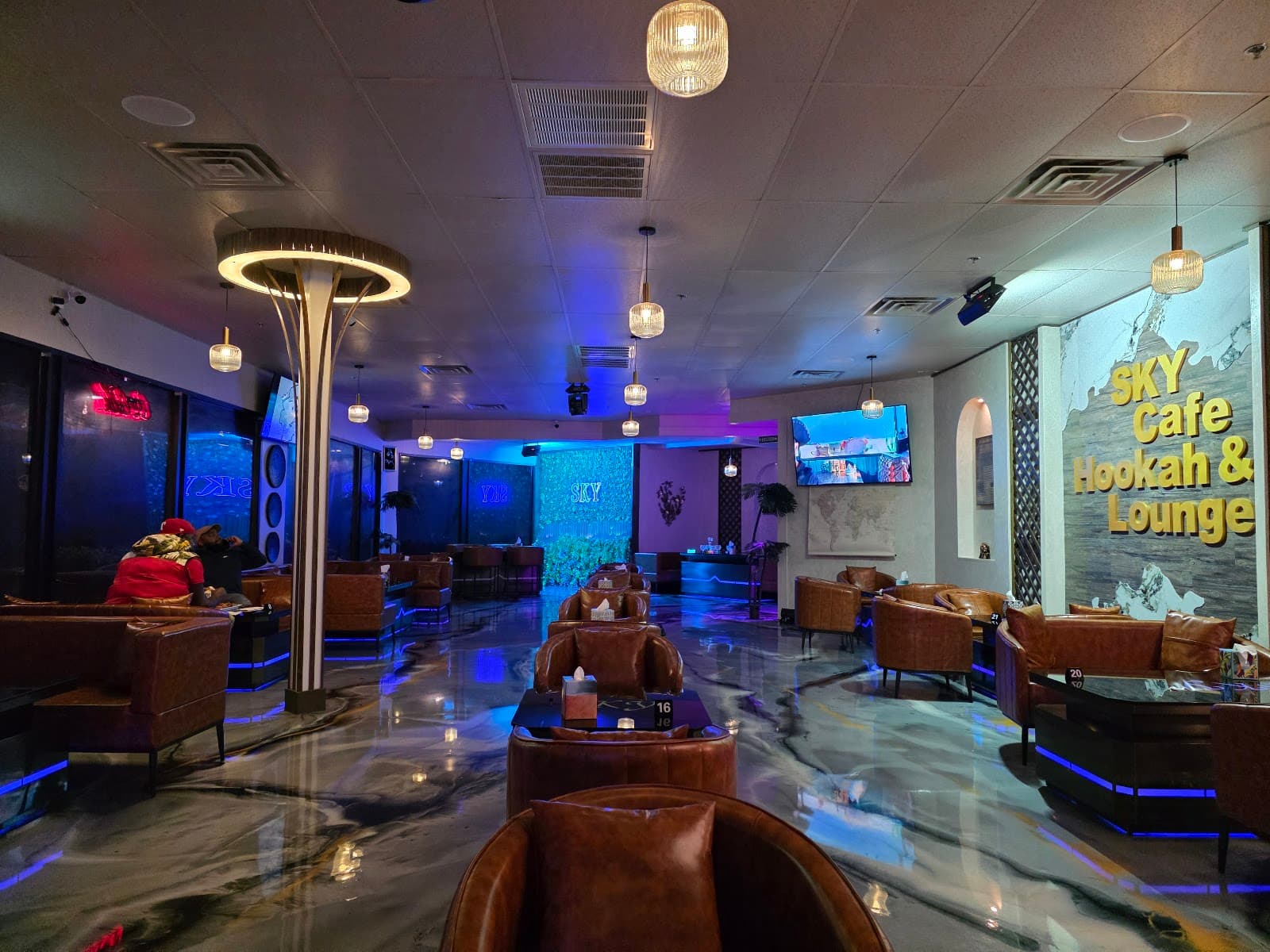 The lounge floor with cognac leather chairs and marble floors